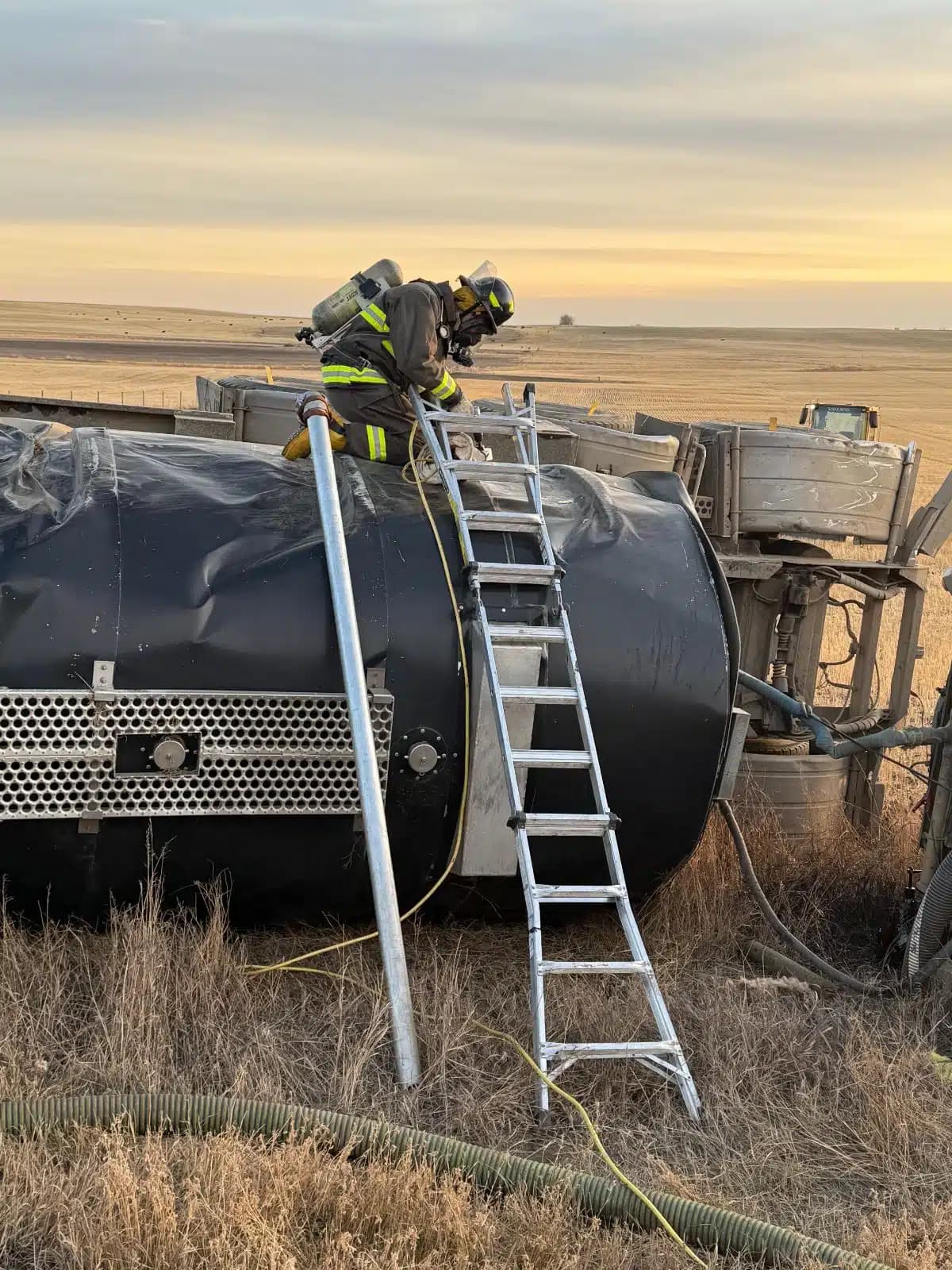 Rapid Response firefighter in bunker gear working on an overturned tanker near Vegreville, Alberta